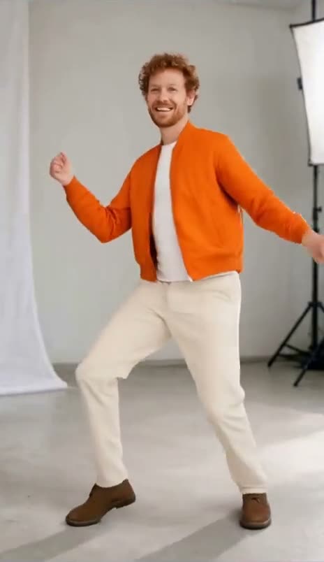 A woman in a white tee and olive cargo pants dances in a white photo studio, swapped into Kai